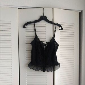 Delicate little black cami top with ruffled bottom